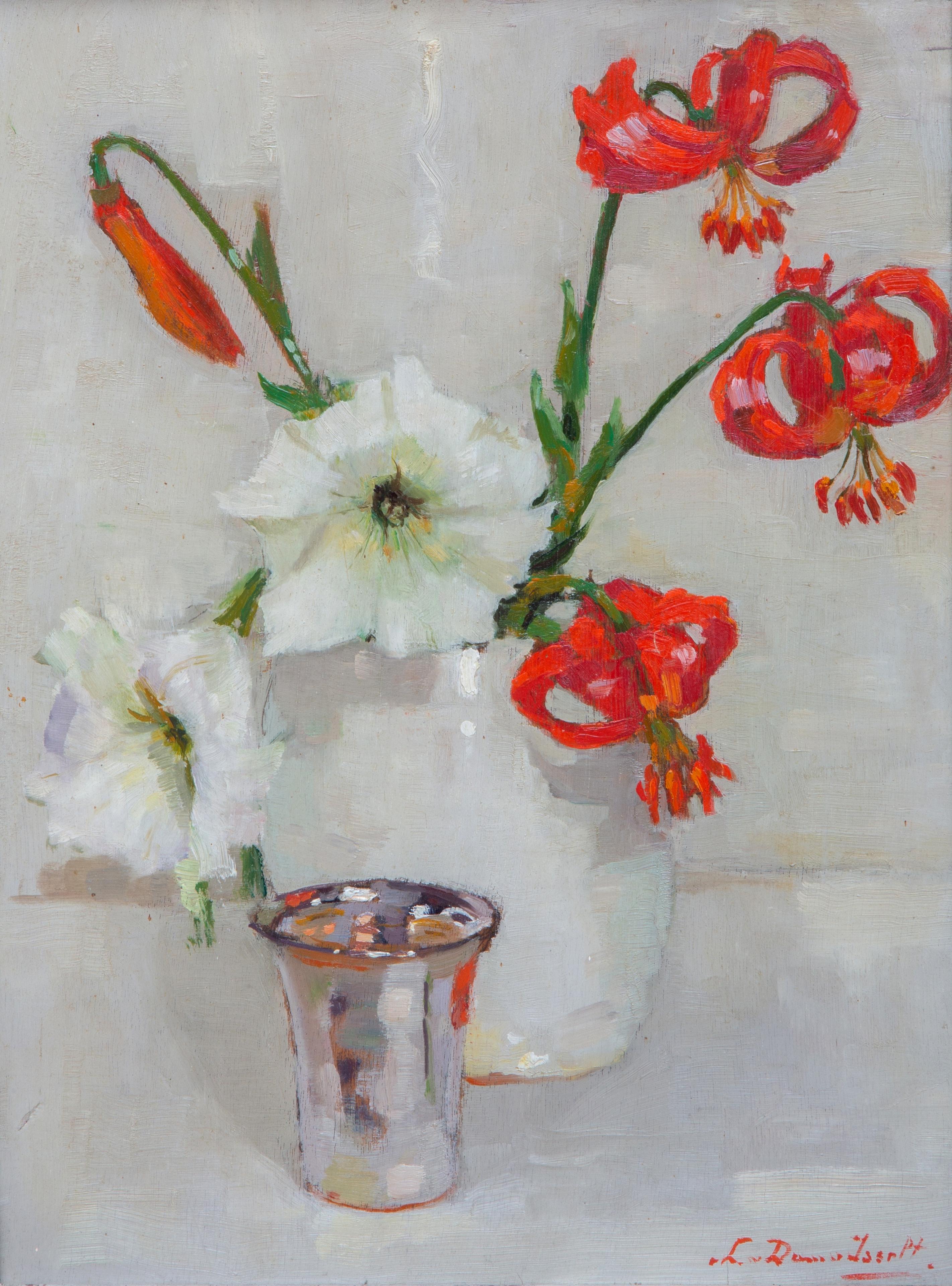 Red lilies in a white vase and a silver cup