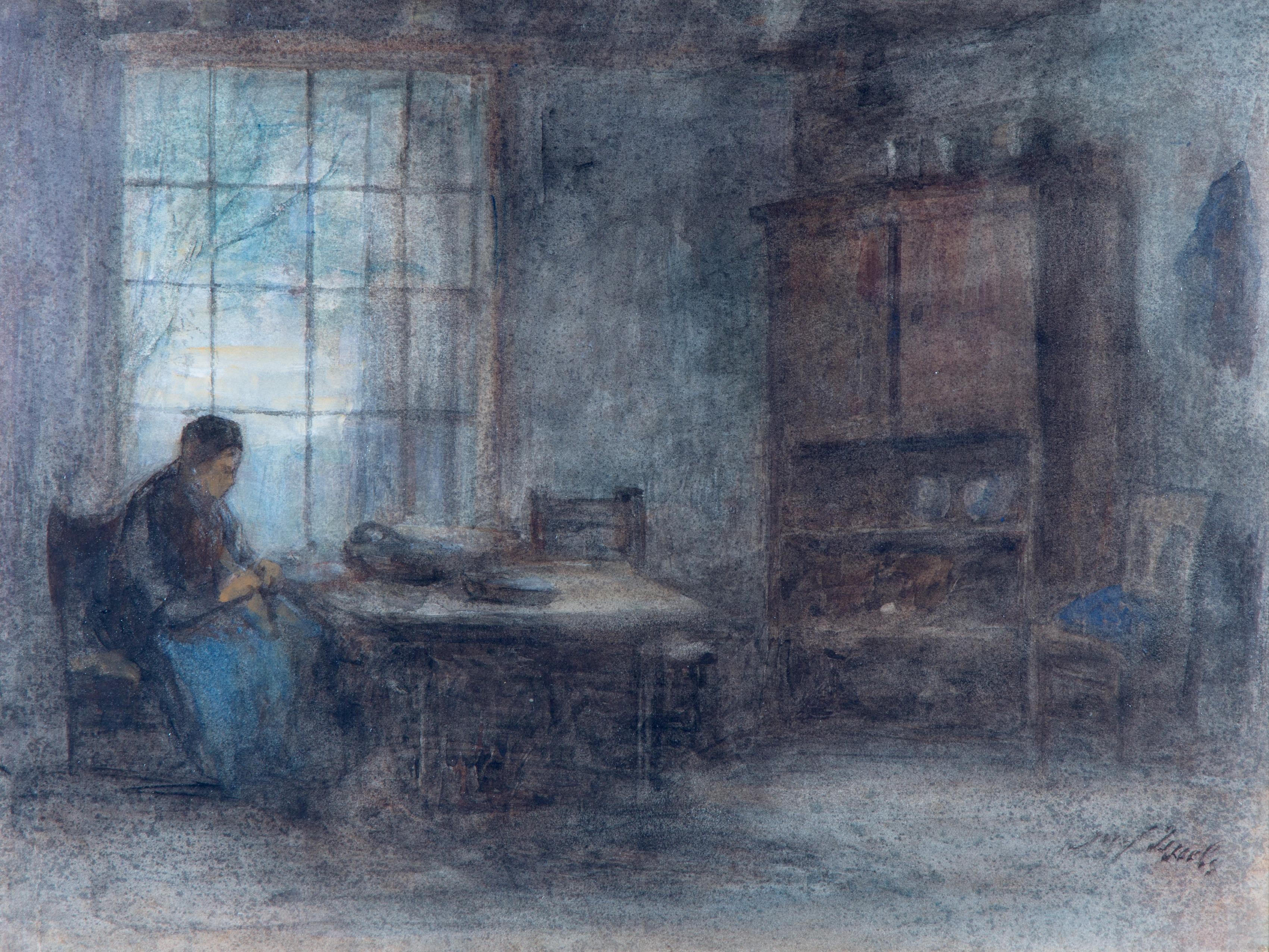 An interior with a woman seated at a table by the window