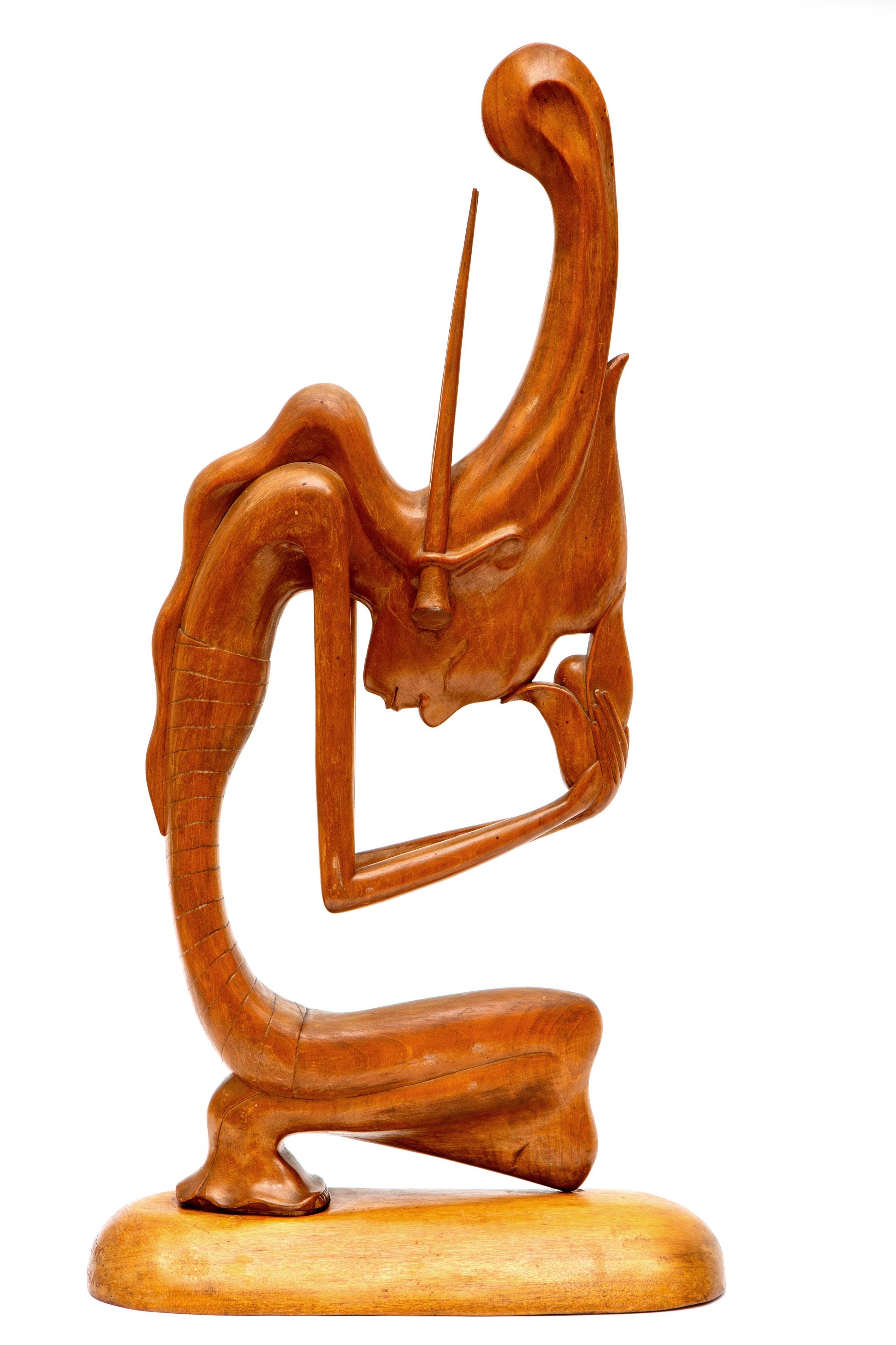 A Balinese wood carved Art Deco stylized figure representing Dewi Sri (Rice Godess)