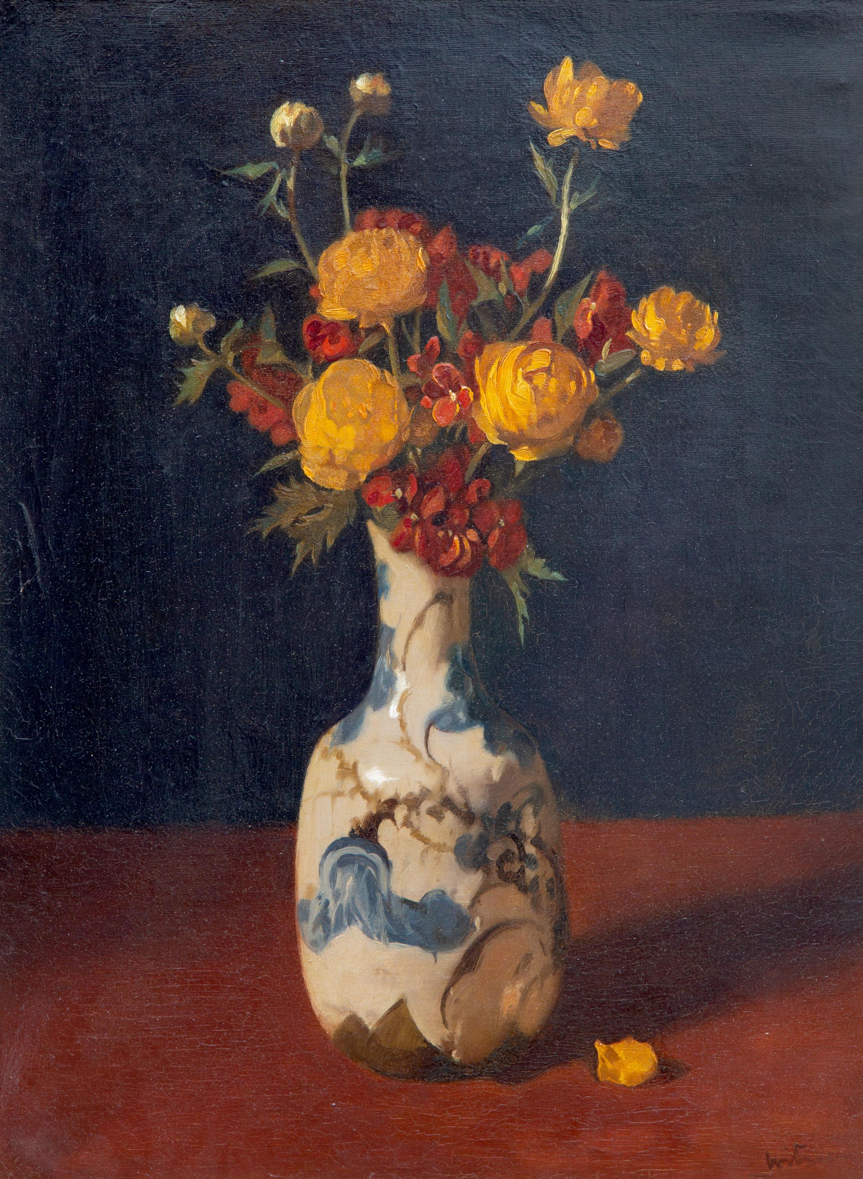 Orange ranunculi in a ceramic vase
