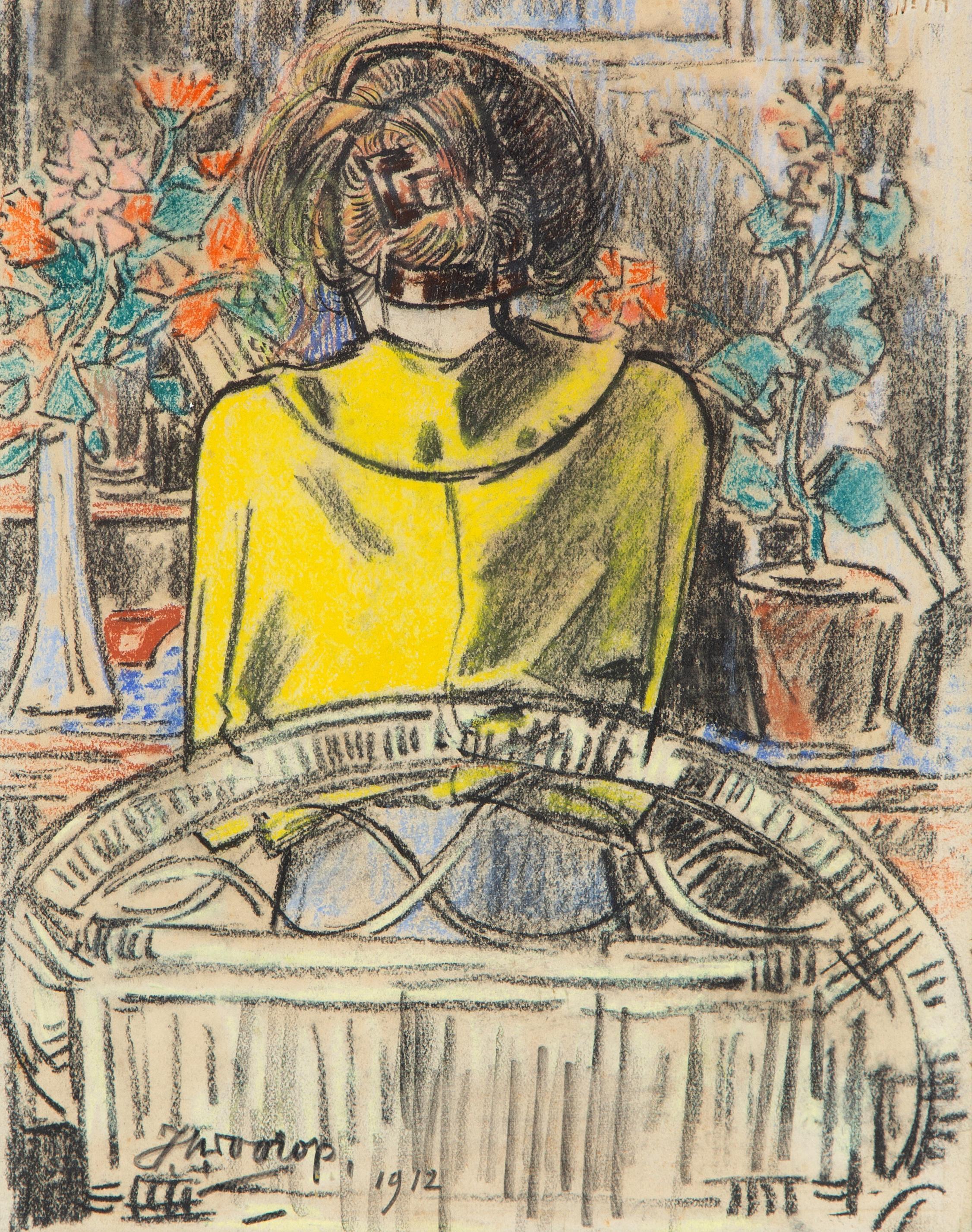 A lady reading at the table, seen from behind