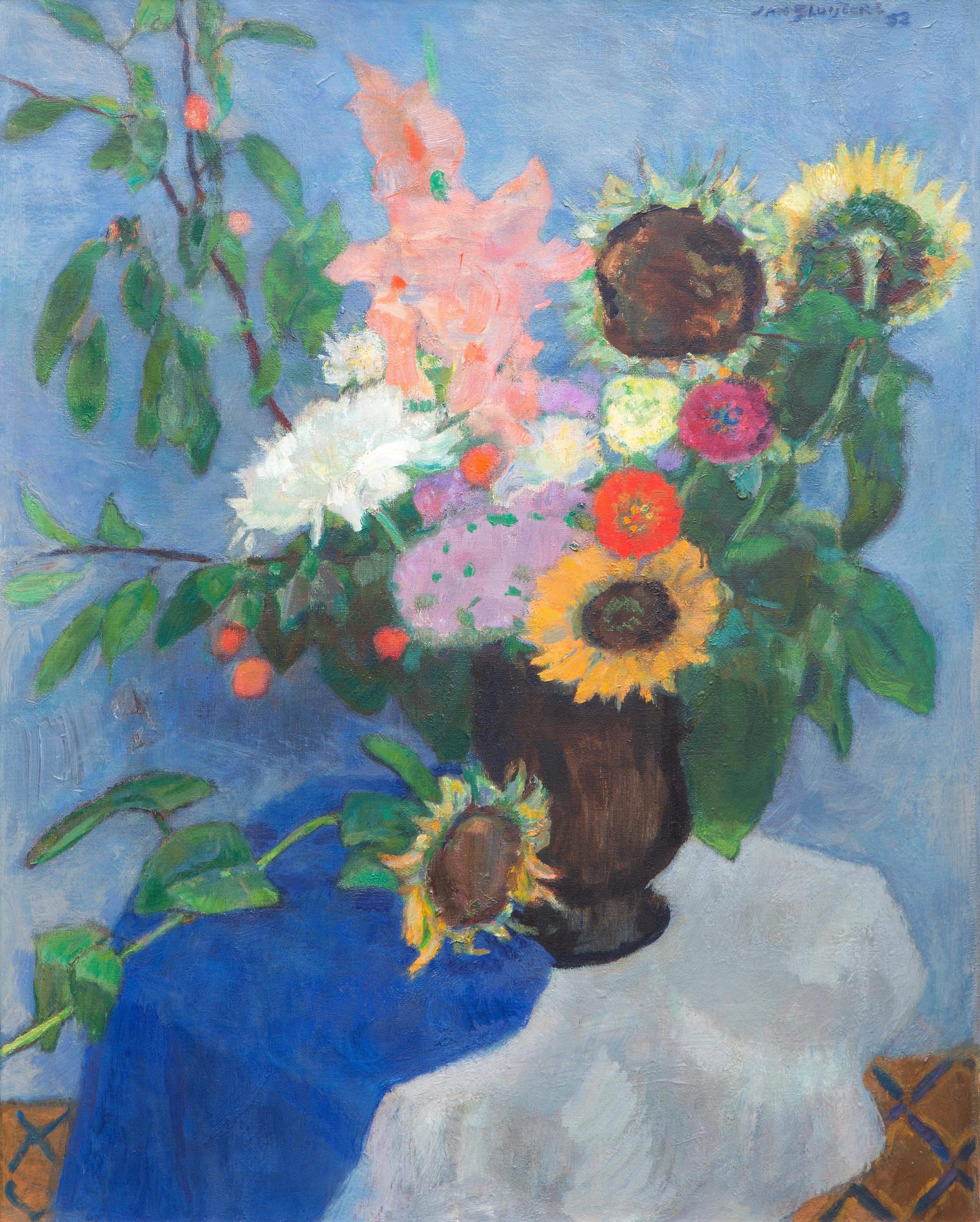 A still life with sunflowers in a vase on a blue cloth A still life with sunflowers in a vase on a blue cloth